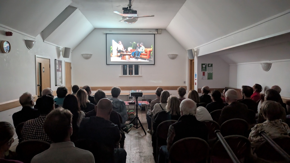 A packed Church Hall viewing the Peoples Emergency briefing film